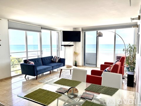 A living room with a blue couch and a television.