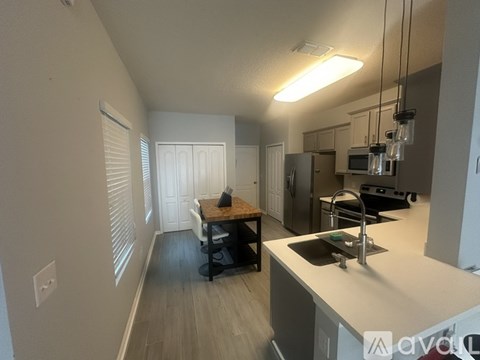 A kitchen with a table and chairs in the middle of the room.