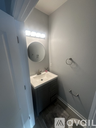 A bathroom with a sink and a mirror.