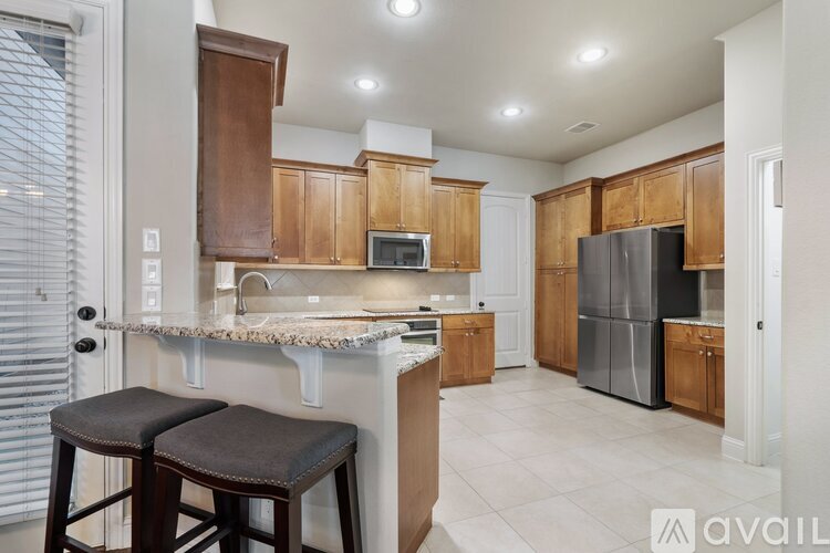A kitchen with wooden cabinets and a white countertop.