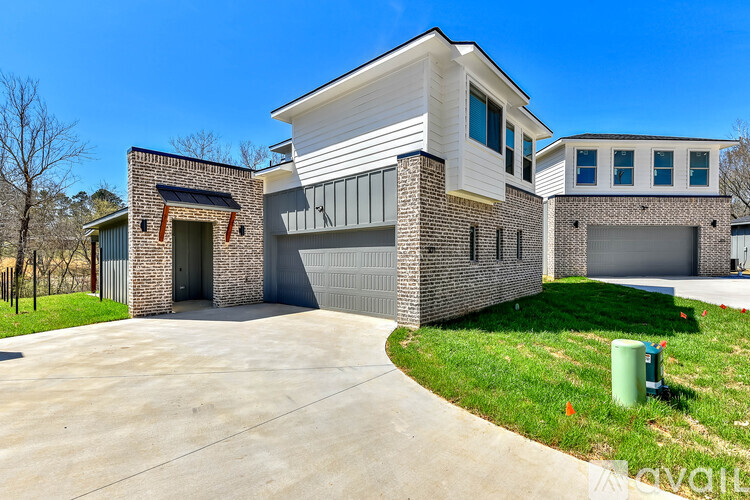 A modern house with a white garage door and a brick chimney.