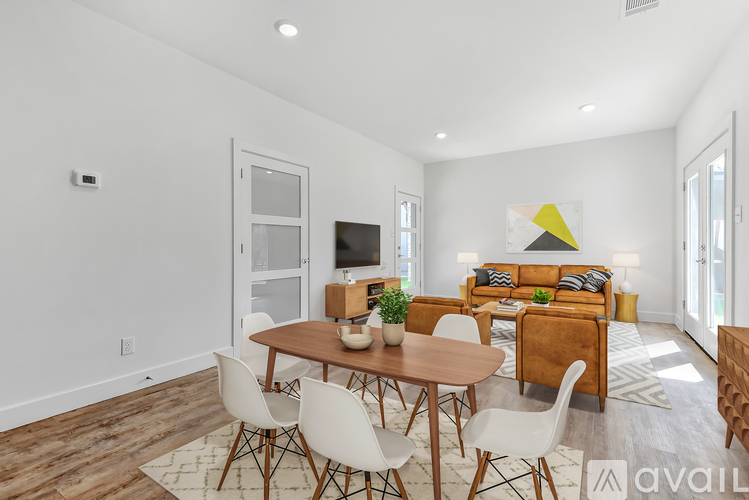 A modern living room with a wooden floor and furniture.