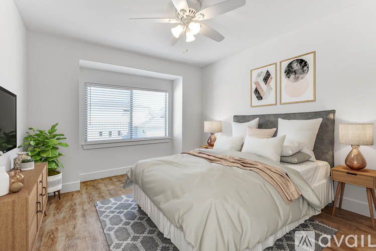 A bedroom with a bed, a ceiling fan, and a window with blinds.
