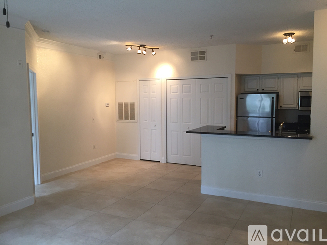 A kitchen area with a counter and cabinets.