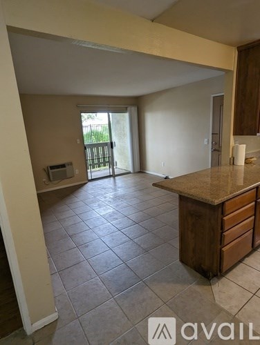 A kitchen area with a counter and cabinets.