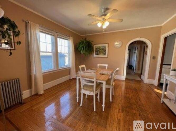 A dining room with a table and chairs.