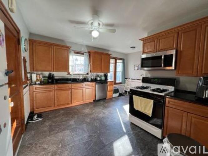A kitchen with wooden cabinets and a black stove top oven.