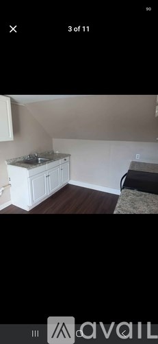 A kitchen with white cabinets and a countertop.