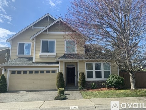 A two-story house with a garage is for sale.