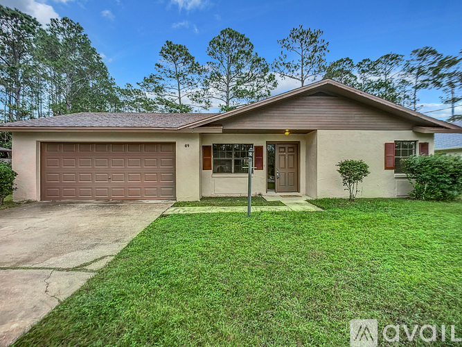A house with a brown roof and a brown garage door is for sale.