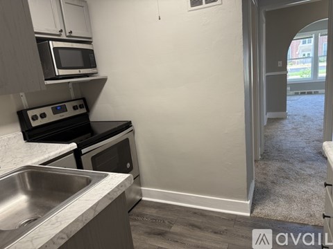 A kitchen with a stove top oven and microwave.