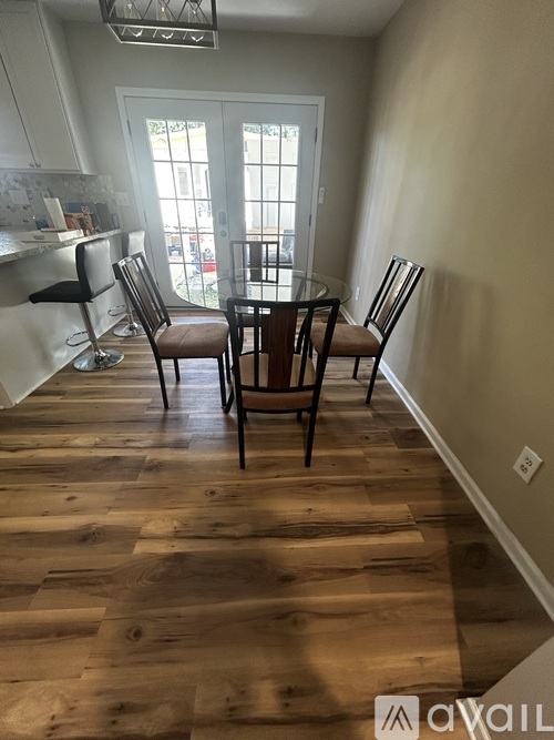 A dining room with a table and chairs.
