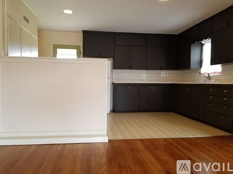 A kitchen with black cabinets and a white countertop.