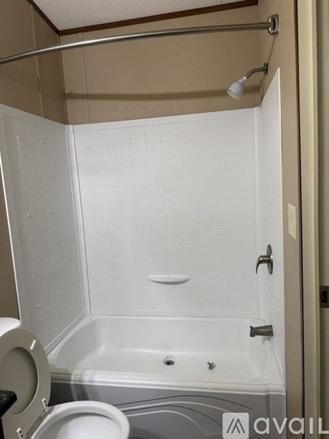 A bathroom with a toilet, tub, and shower.