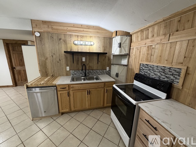 A kitchen with wooden cabinets and a white countertop.