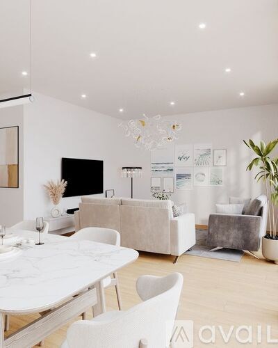 A modern living room with a white dining table and chairs.
