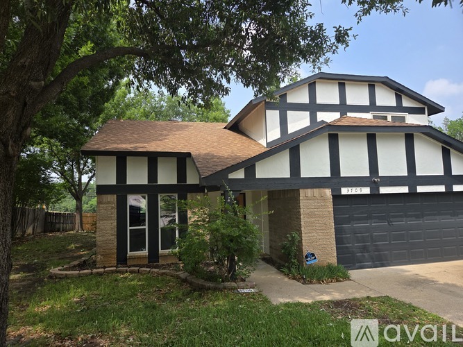 A house with a black and white facade is for sale.