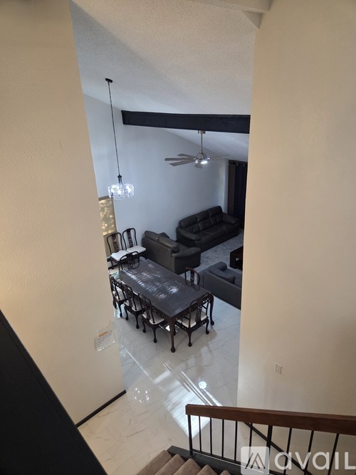 A living room with a couch and a dining table.