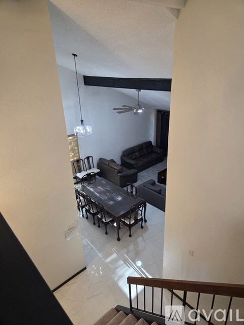 A living room with a couch and a dining table.