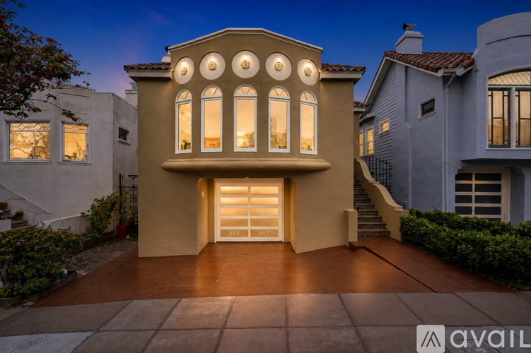 A house with a large front door and windows is shown in the image.