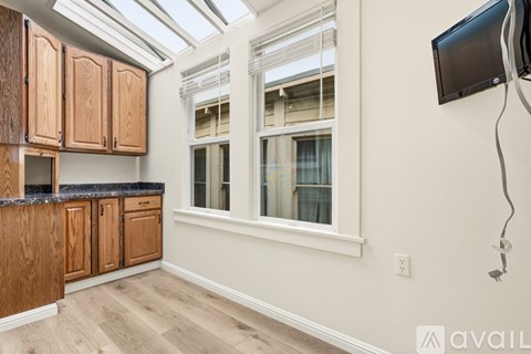 A kitchen with wooden cabinets and a window.