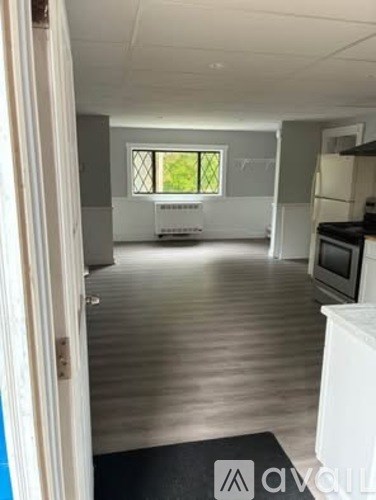 A kitchen with a refrigerator, oven, and microwave.