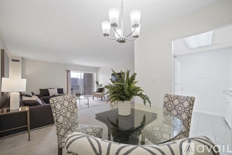 A living room with a glass table and chairs.