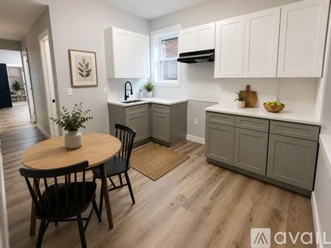 A kitchen with a table and chairs in the middle of the room.