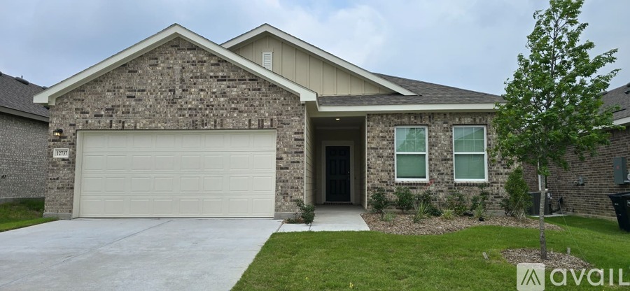 A house with a stone facade and a white garage door.