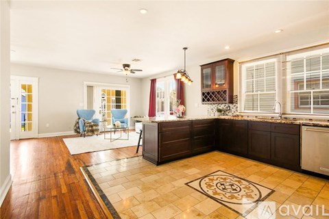 A kitchen with brown cabinets and a tiled floor.