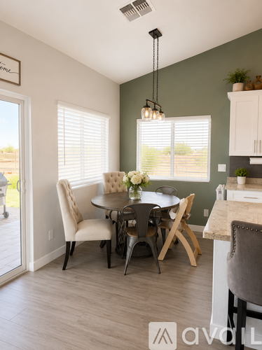 A dining room with a table set for four.