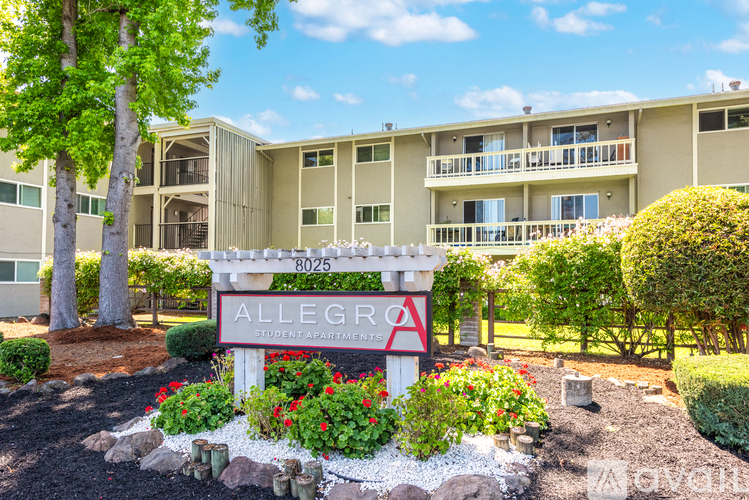 A sign for Allegra Student Apartments is in front of a building.