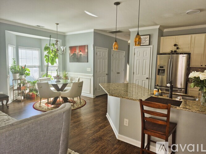 A kitchen with a table and chairs in the middle of the room.