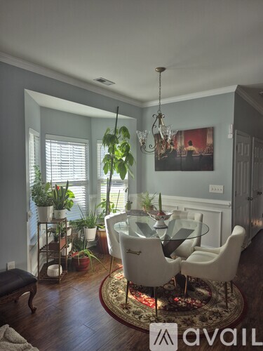 A dining room with a glass table and chairs.