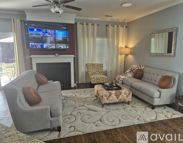 A living room with a television, a fireplace, and a couch.