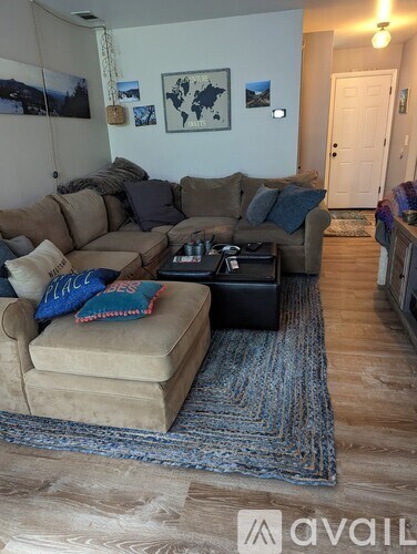 A living room with a large sectional sofa and a coffee table.