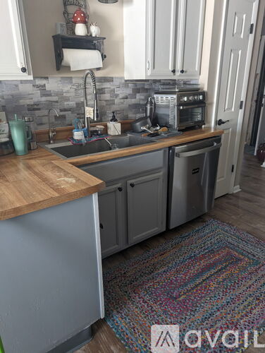 A kitchen with a sink and a toaster on the counter.