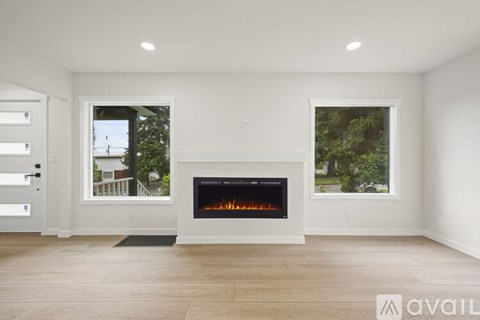 A modern living room with a fireplace and two windows.
