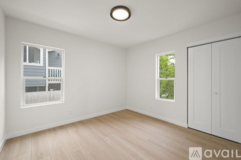 A room with a window and a door is available for rent.