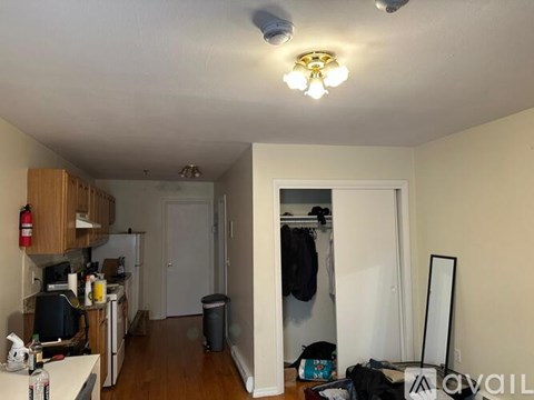 A kitchen with a microwave, oven, and sink.