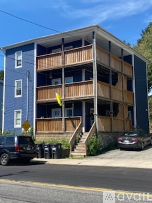 A blue building with wooden balconies and a yellow flag.