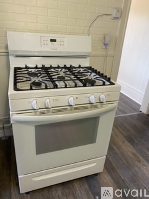A white gas stove with a white oven in a kitchen.