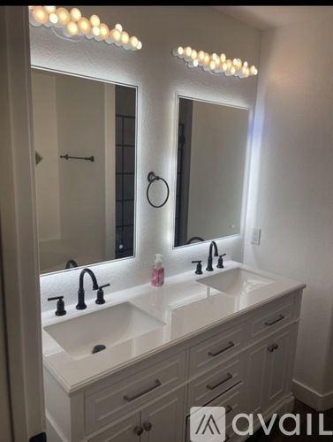 A bathroom vanity with a mirror above it.
