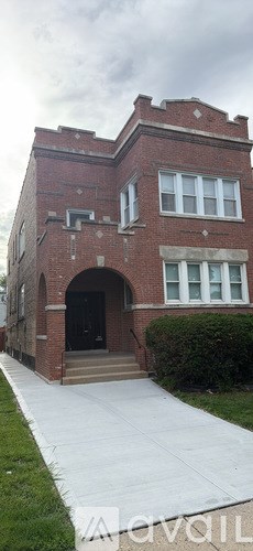 A red brick building with a black door and windows.