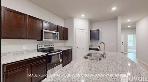 A kitchen with brown cabinets and a granite countertop.