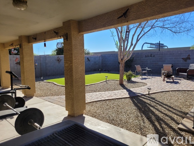A gym with weights and a green area outside.