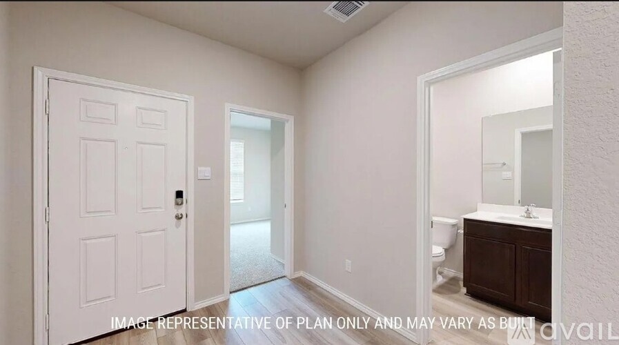 A white door is on the left and a bathroom is on the right.