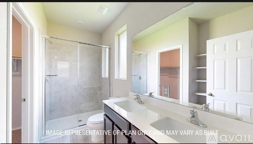 A bathroom with a sink, mirror, and shower.