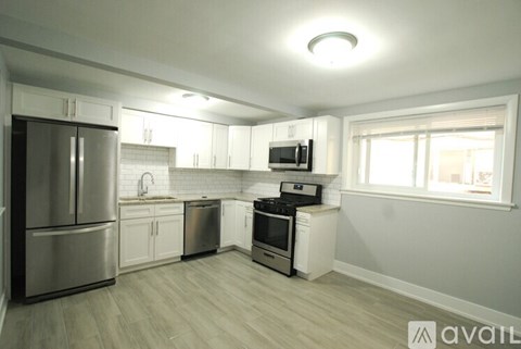 A kitchen with a refrigerator, microwave, oven, and stove.