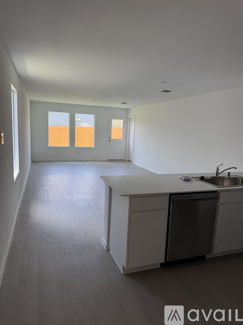 A kitchen with a sink and a window.